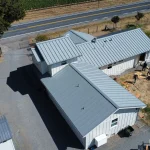 Drone view of a residential home with a new metal roof replacement in Santa Rosa